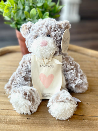 a soft mini stuffed bear with a pink heart and love you sentiment