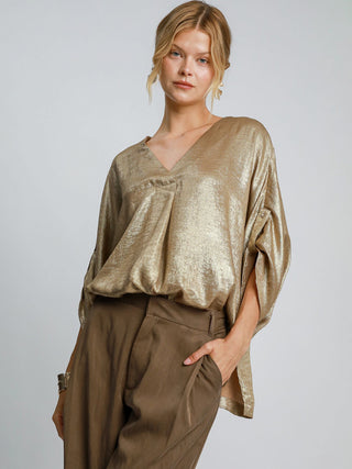 a classy oversized gold metallic v neck blouse that shimmers