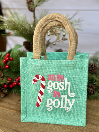 a cute mint green holiday gift tote bag that says oh by gosh by jolly