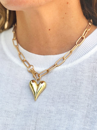 a golden plump heart pendant necklace with a large gold chain link