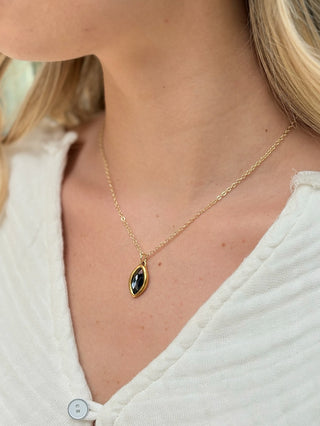 delicate gold chain holds a smoky nearly black antiqued crystal graphite charm