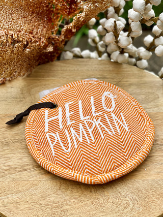 a festive orange pot holder set with hello pumpkin on front and an autumnal dish towel