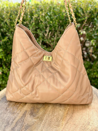 a beige and tan quilted vegan leather purse with gold hardware