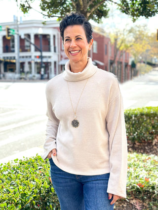 a warm and sophisticated cream turtleneck popover sweater