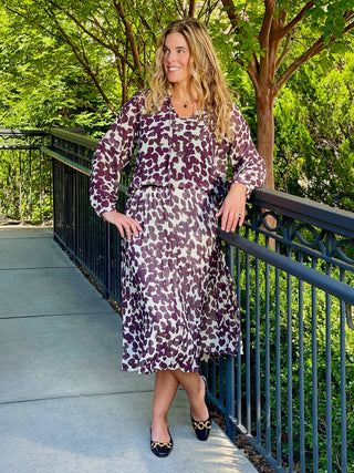 a flowy pleated midi skirt with a chocolate spot design paired with a matching blouse