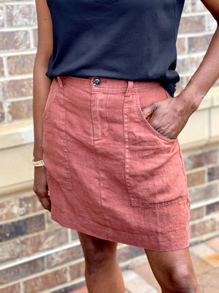 a stylish clay red linen skirt with deep pockets and zip up front