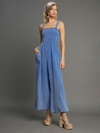 a sleeveless lightweight blue cotton gauze jumpsuit with flowy wide legs and front pockets