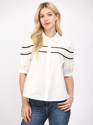 an off white button up blouse with black stripes and three quarter puff sleeves