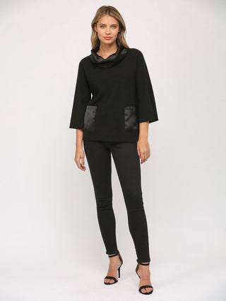 a fun black cowl neck sweater top with silk accents worn with black jeans