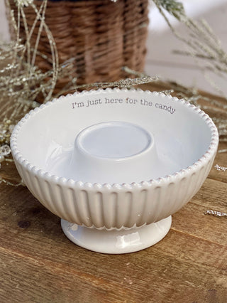 a white ceramic candy bowl that says i'm just here for the candy