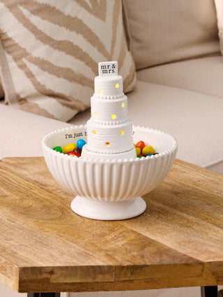 a white ceramic holiday candy bowl with a decor sitter spot in the middle