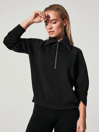 a lightweight black sweatshirt with a collar and half zipper perfect as athleisure or comfortable casual fashion