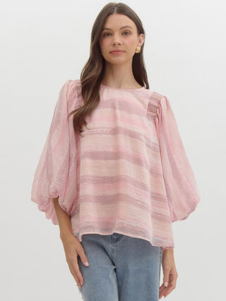 a pink flowy striped blouse with puff sleeves 