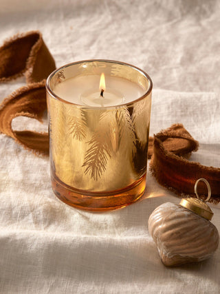 an elegant gilded gold holiday pine needle candle