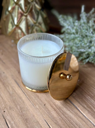 a frosted wood grain candle with a golden lid