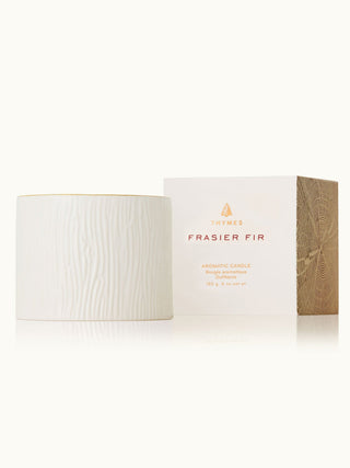 an elegant white wood grain holiday candle with an amazing holiday scent of mountain air