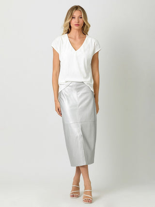 a simple white velvet cupro v neck t shirt with side slits paired with a silver skirt