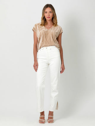 a simple sand velvet cupro v neck t shirt with side slits paired with white pants