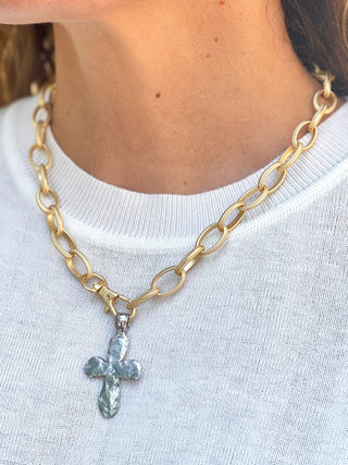 a large gold link chain necklace with front lobster clasp and silver hammered cross pendant