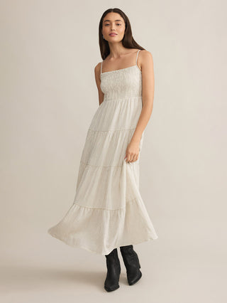 a cream striped sleeve less tiered maxi dress