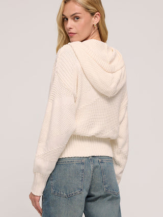 a lightweight cream hooded knit sweater with a self tie cinched waist