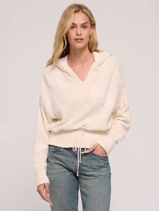 a lightweight cream hooded knit sweater with a self tie cinched waist