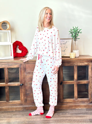 soft white jogger pajama pants with red hearts and a matching shirt