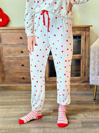 soft white jogger pajama pants with red hearts and an elastic waist