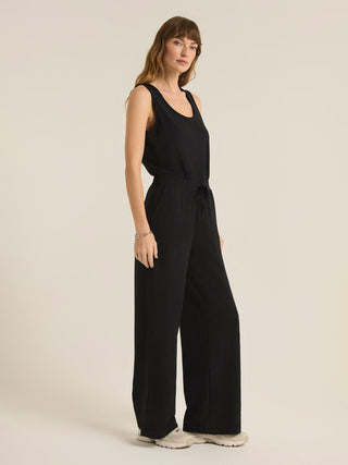 the softest black sleeveless jumpsuit with a tie at the waist and easy pockets