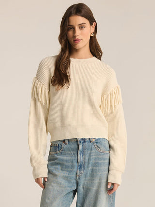 cream crew neck sweater with long sleeves and fringe detail at the shoulders