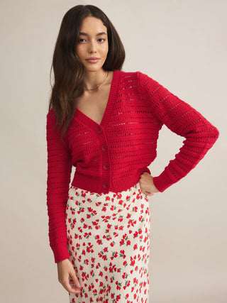 a red cropped button up open stitch sweater