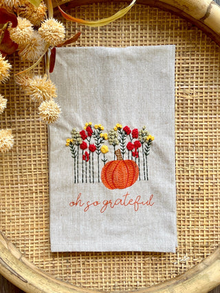 an embroidered fall towel with plump pumpkins and oh so grateful print